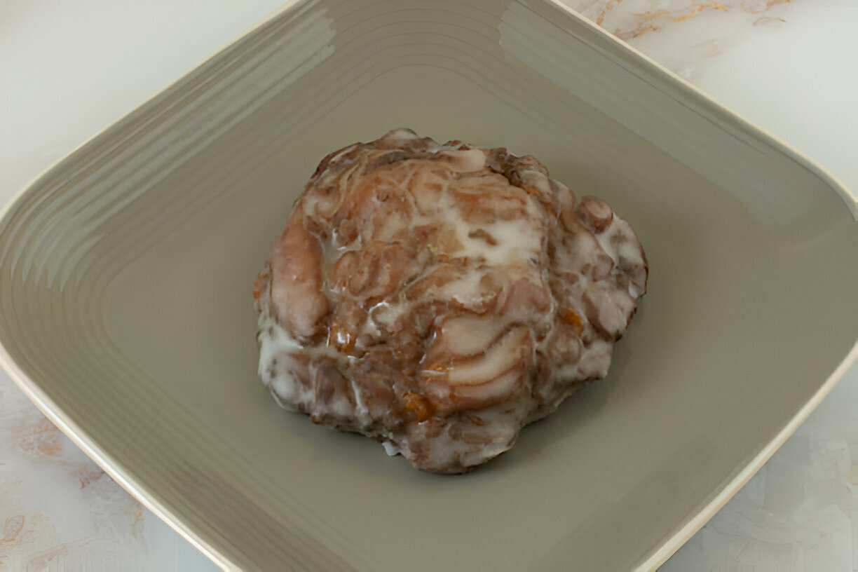 A dish featuring a gelatinous meat preparation on a light green plate.